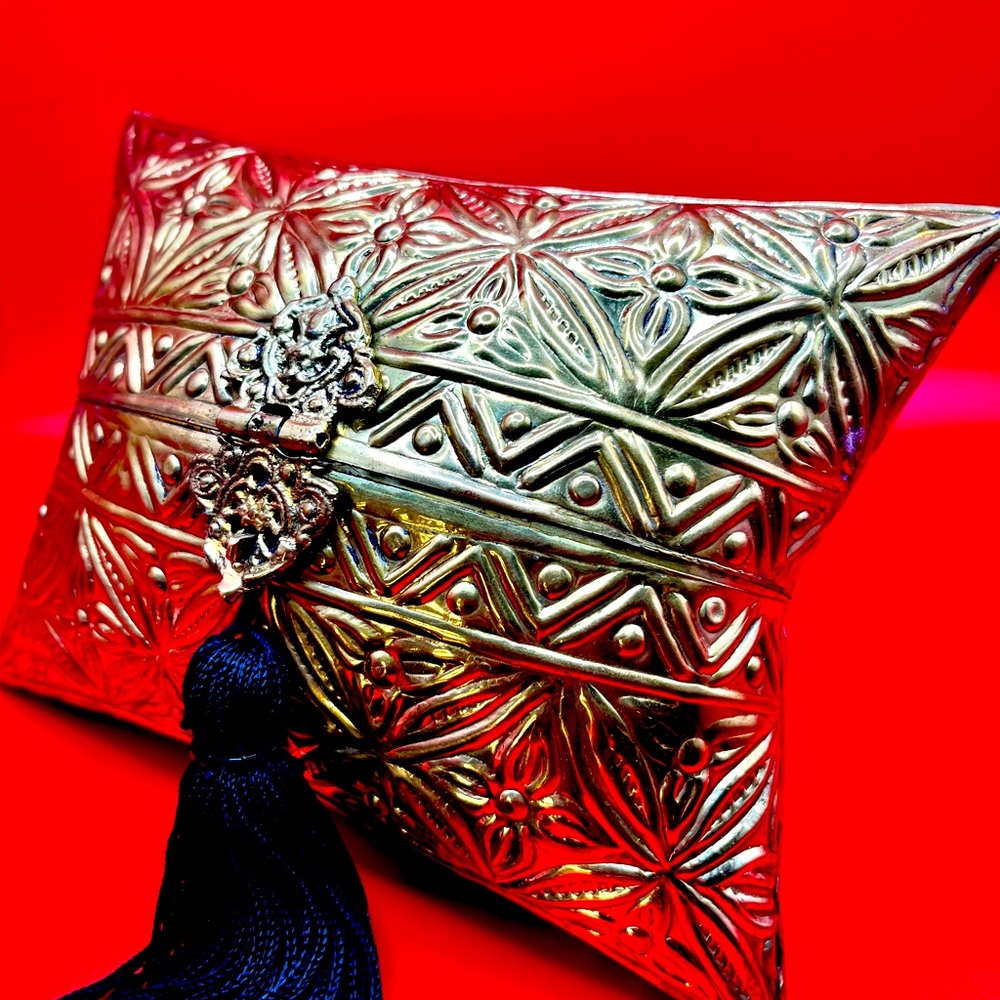 Zara gold metal clutch with black tassel.